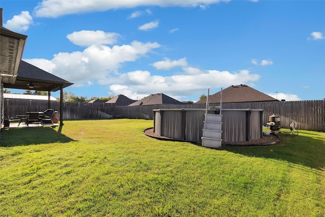 view of yard with a swimming pool and a patio area