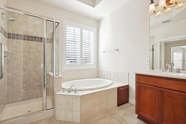 bathroom with vanity, tile patterned flooring, and plus walk in shower