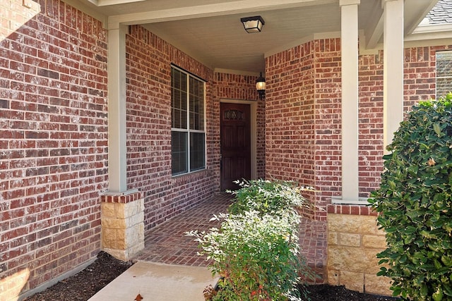 view of exterior entry featuring a porch