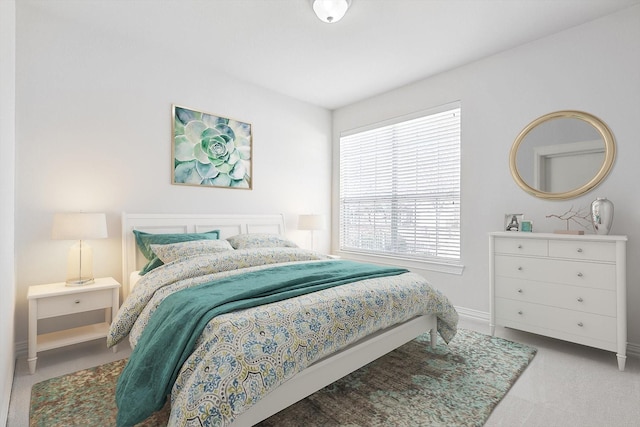 bedroom featuring light colored carpet