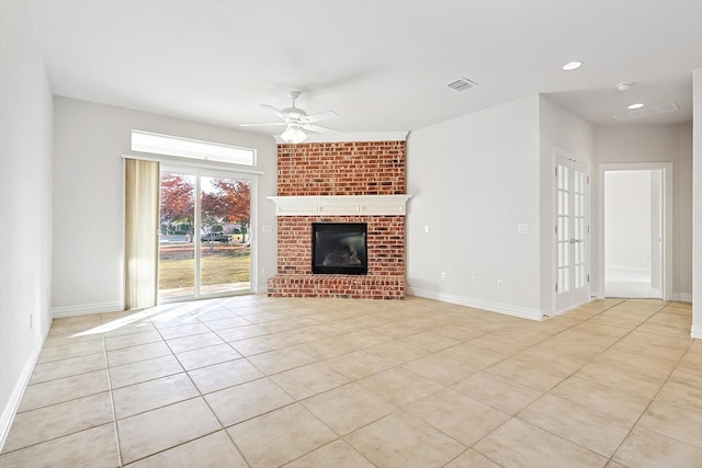 unfurnished living room with ceiling fan, light tile patterned floors, and a brick fireplace