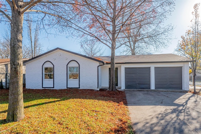 ranch-style house featuring a garage and a front yard