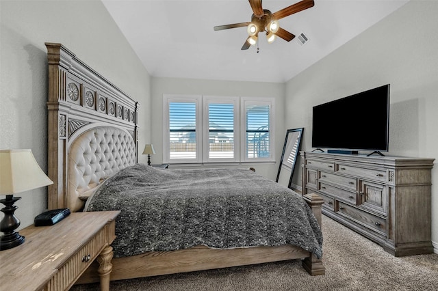 carpeted bedroom featuring lofted ceiling and ceiling fan