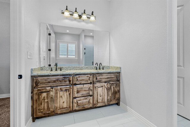 bathroom with tile patterned flooring and vanity