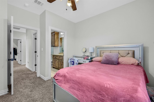 carpeted bedroom featuring ceiling fan and ensuite bathroom