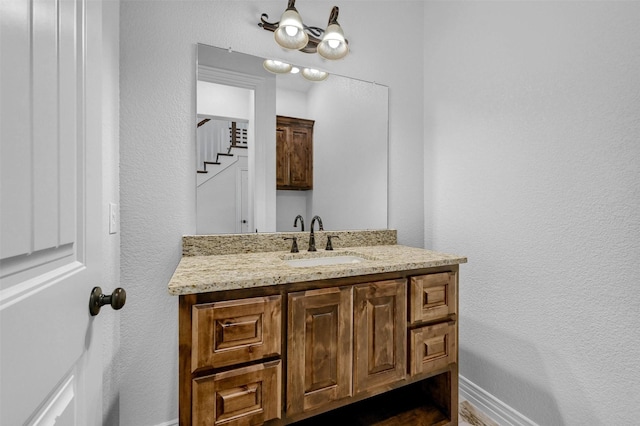 bathroom featuring vanity and a notable chandelier