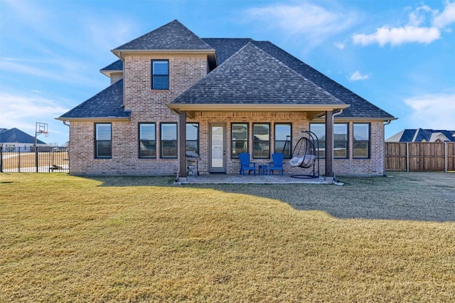 rear view of property featuring a patio and a lawn