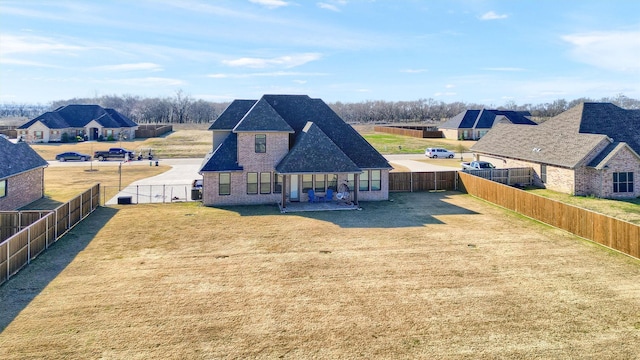 back of property with a yard and a patio