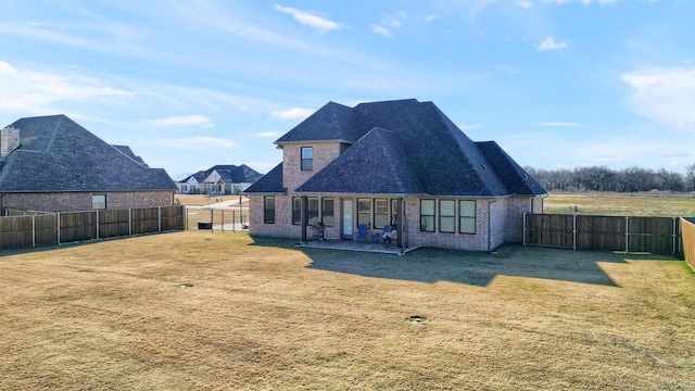 rear view of house with a lawn