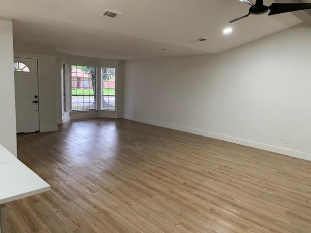 unfurnished living room with hardwood / wood-style floors and ceiling fan