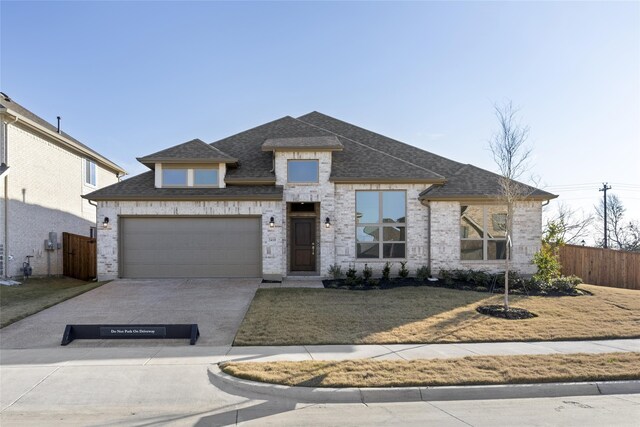 view of front of home featuring a garage and a front yard