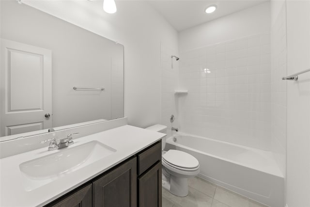 full bathroom featuring tiled shower / bath, vanity, toilet, and tile patterned flooring