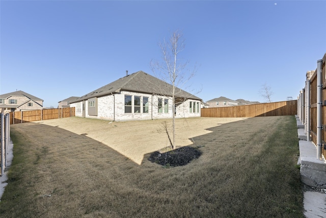 rear view of property with a lawn