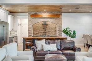 living room featuring beamed ceiling