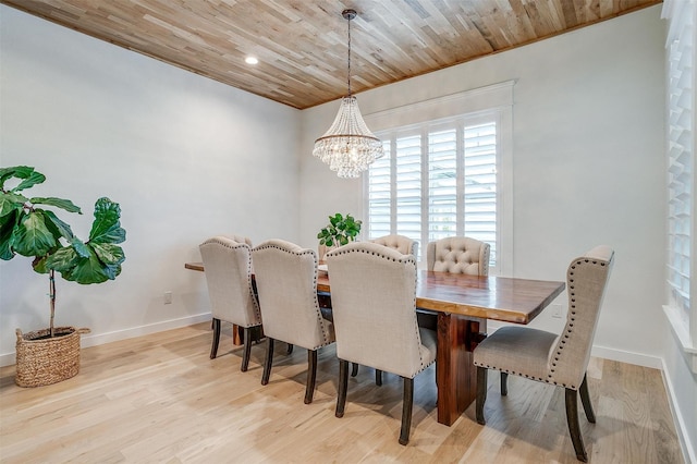 dining room featuring light hardwood / wood-style flooring, wood ceiling, and an inviting chandelier