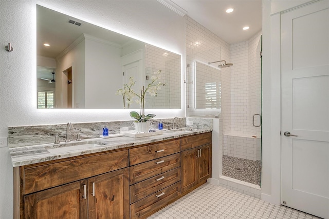 bathroom featuring vanity, crown molding, ceiling fan, and walk in shower