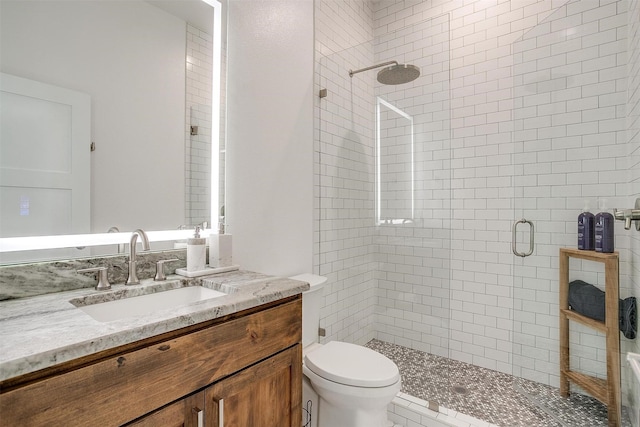 bathroom featuring vanity, an enclosed shower, and toilet