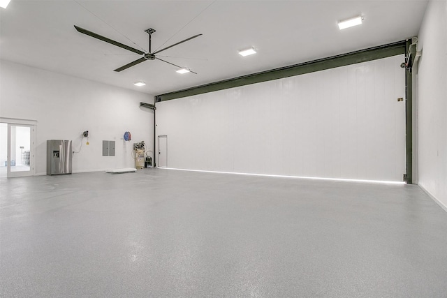 garage featuring ceiling fan and electric panel