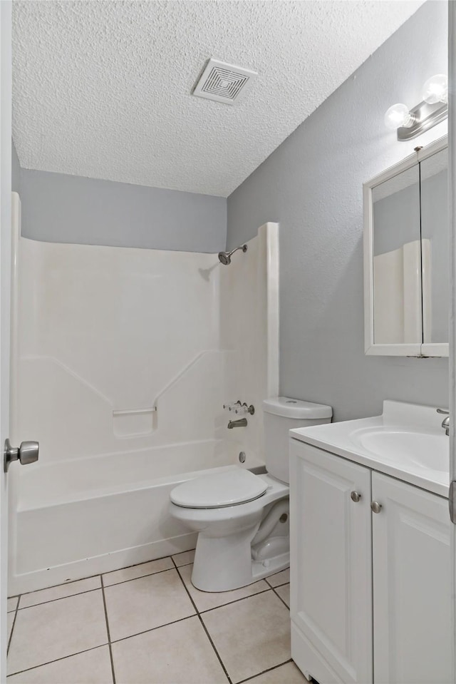 full bathroom featuring bathtub / shower combination, tile patterned flooring, vanity, toilet, and a textured ceiling