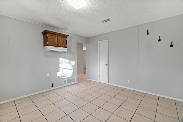 unfurnished room with a textured ceiling