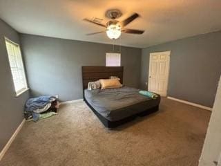 bedroom with ceiling fan and dark carpet