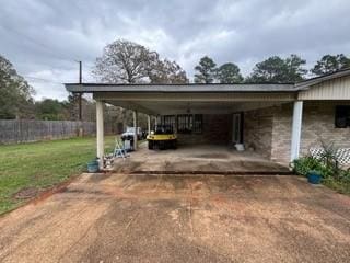 view of vehicle parking featuring a yard and a carport