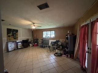 interior space with tile patterned flooring and ceiling fan