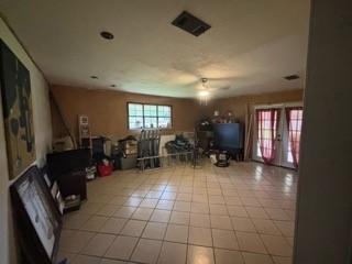 living room with french doors and light tile patterned floors