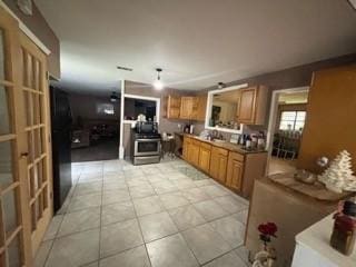 kitchen featuring light tile patterned floors, hanging light fixtures, and french doors