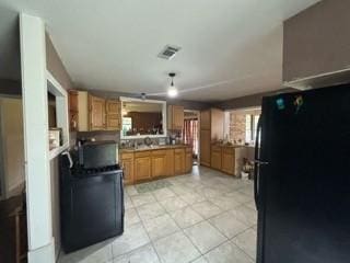 kitchen featuring black refrigerator