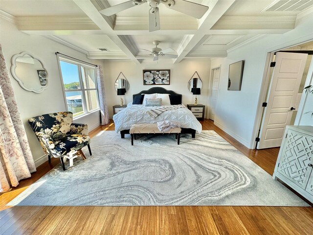 bedroom featuring beam ceiling, ornamental molding, ceiling fan, and coffered ceiling