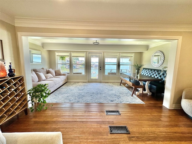 interior space featuring wood-type flooring and ornamental molding