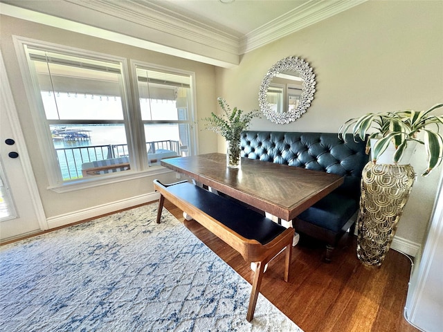 dining area with breakfast area, wood-type flooring, and ornamental molding