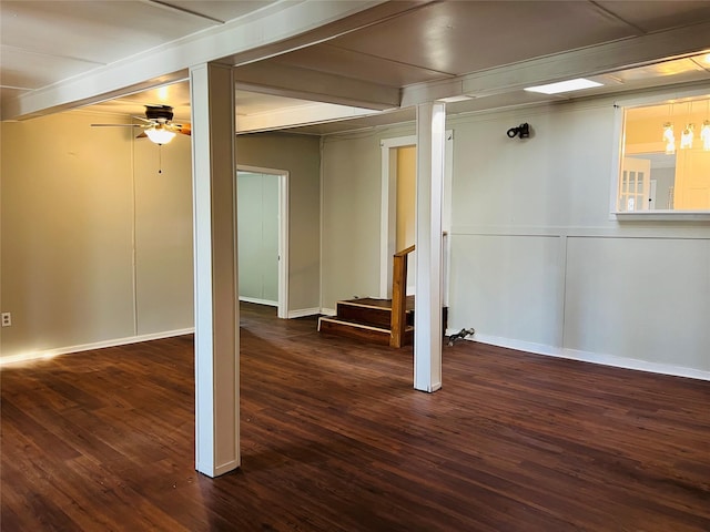 basement featuring dark hardwood / wood-style floors and ceiling fan