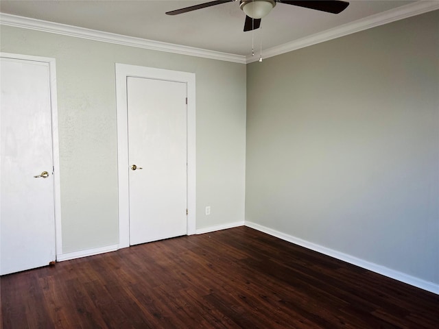 unfurnished bedroom featuring dark wood-type flooring, ornamental molding, and ceiling fan