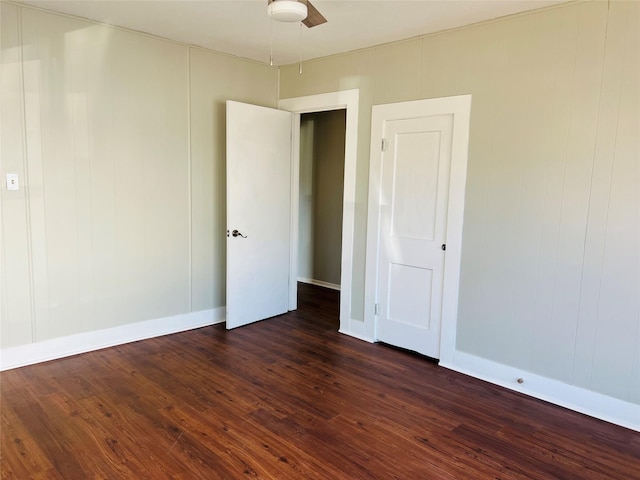 empty room featuring dark hardwood / wood-style floors and ceiling fan