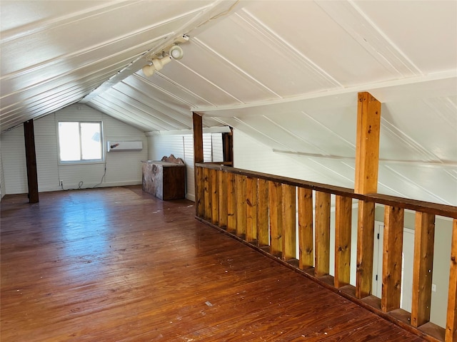 bonus room featuring vaulted ceiling, dark wood-type flooring, and a wall mounted air conditioner