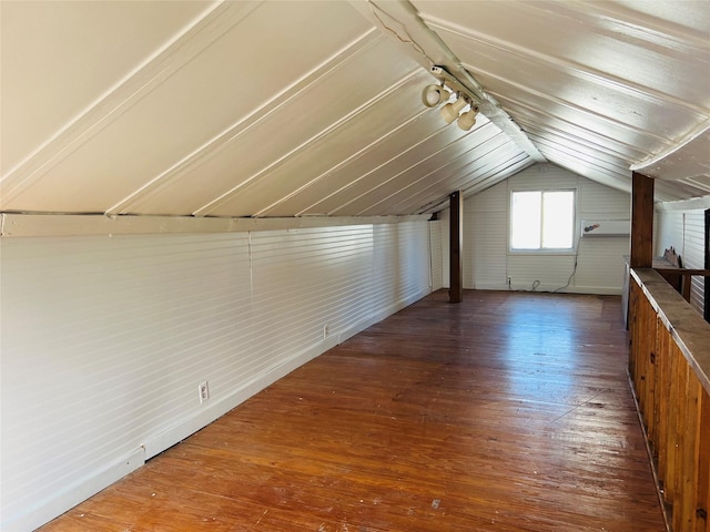 additional living space with lofted ceiling and dark hardwood / wood-style flooring