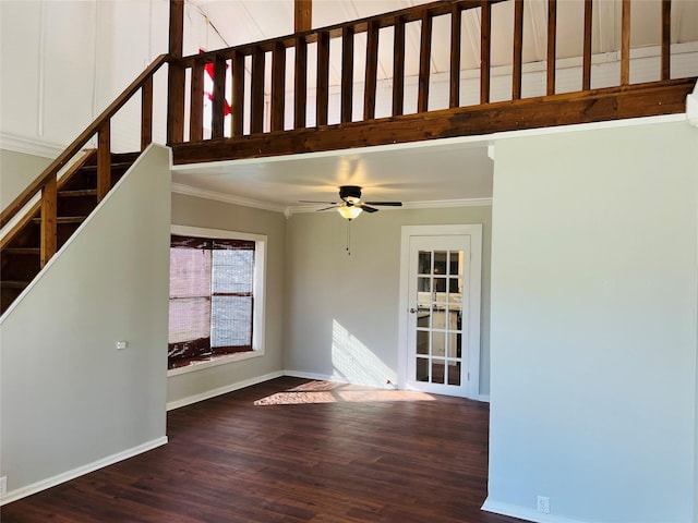 unfurnished living room featuring dark wood-type flooring, ceiling fan, and crown molding