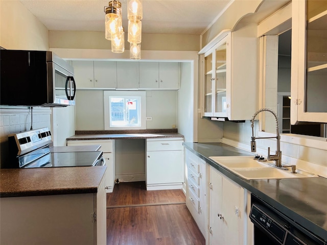 kitchen featuring appliances with stainless steel finishes, decorative light fixtures, white cabinetry, sink, and dark hardwood / wood-style flooring