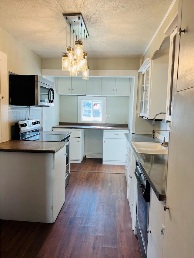 kitchen with pendant lighting, sink, appliances with stainless steel finishes, dark hardwood / wood-style floors, and white cabinets