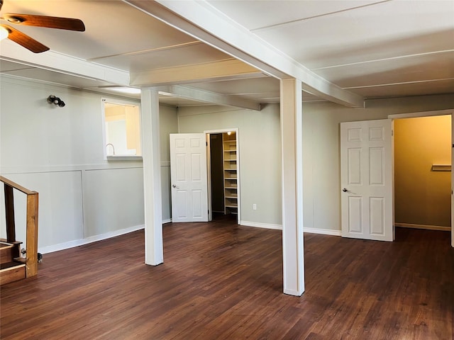 basement with ceiling fan and dark hardwood / wood-style flooring