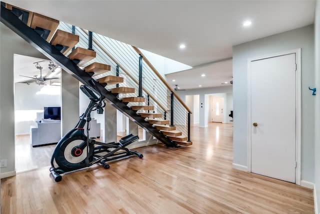 workout area featuring ceiling fan and light wood-type flooring