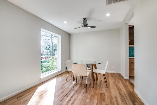 dining space featuring light hardwood / wood-style flooring, ceiling fan, and plenty of natural light