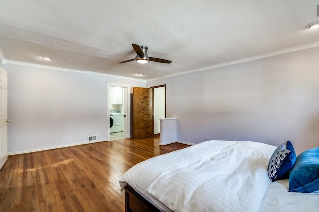 bedroom with crown molding, washer / dryer, wood-type flooring, and ceiling fan