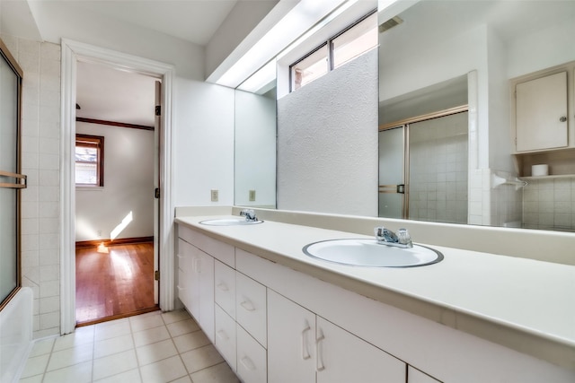 bathroom featuring ornamental molding, tile patterned floors, combined bath / shower with glass door, and vanity