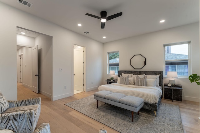 bedroom with multiple windows, ceiling fan, and light hardwood / wood-style flooring