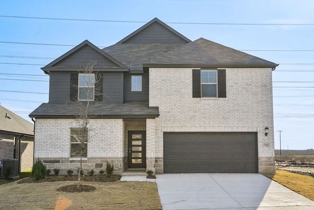 view of front facade with a garage and central AC unit