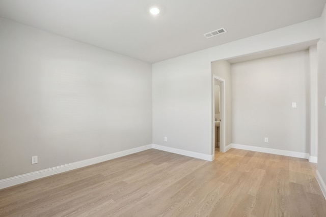 empty room with light hardwood / wood-style flooring