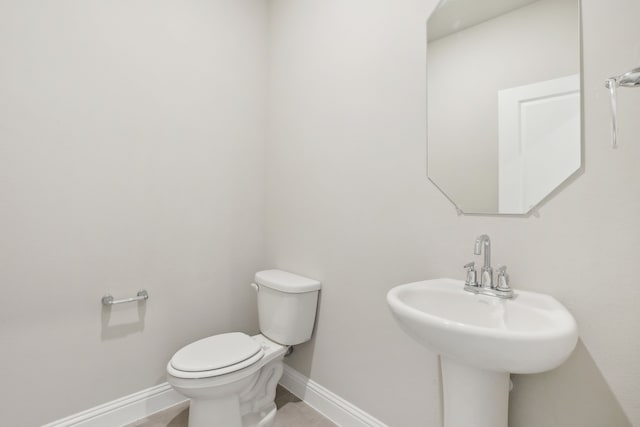 bathroom with sink, tile patterned floors, and toilet